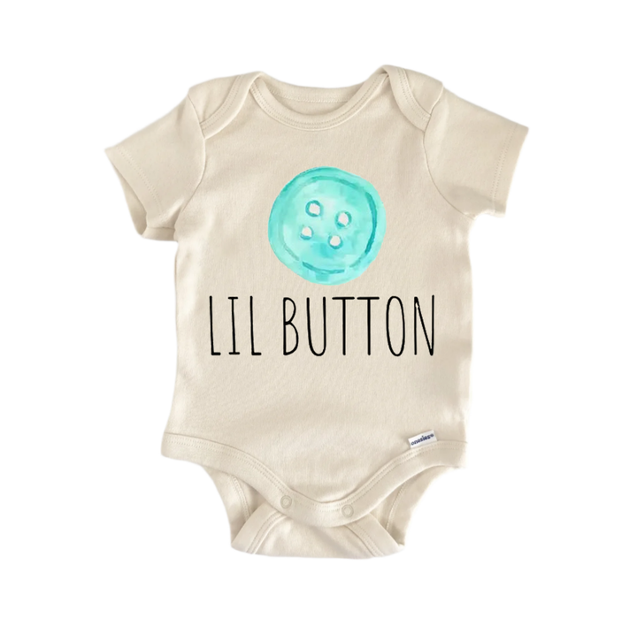 A beige baby onesie with a teal button printed on it and the text "LIL BUTTON" printed below it.