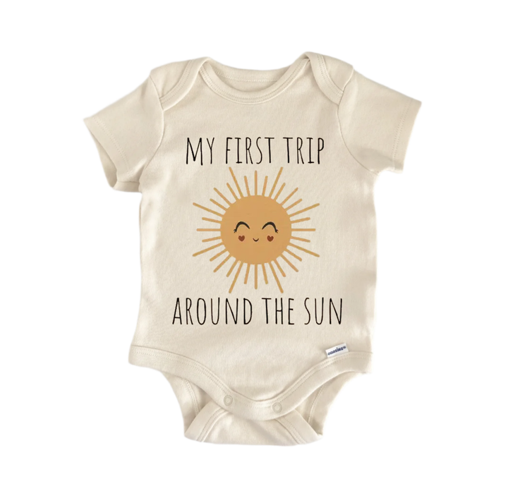 A beige baby onesie with a sun graphic and the text "My first trip around the sun" printed on it.