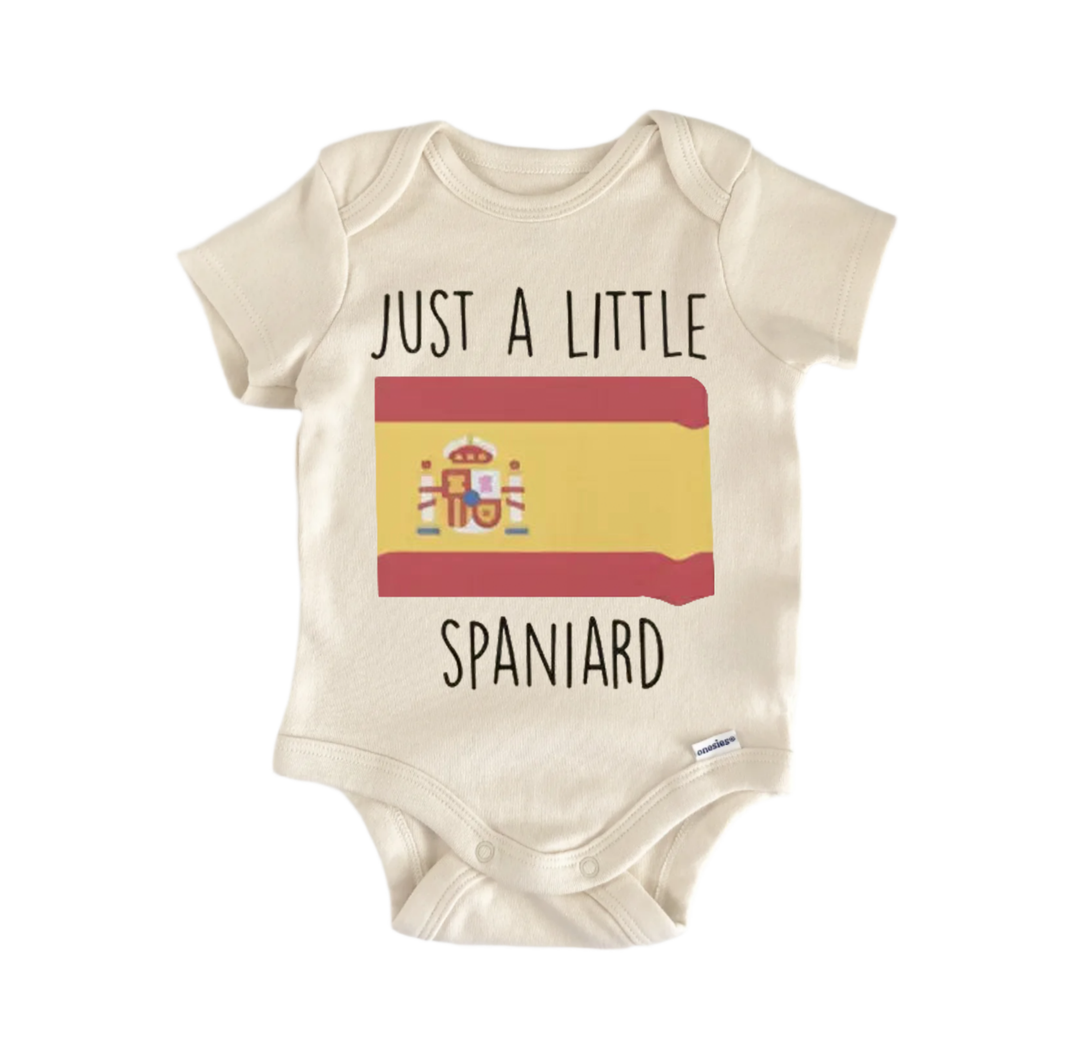 A beige baby onesie with the text "JUST A LITTLE SPANISH" printed on it, along with a small Spanish flag graphic.