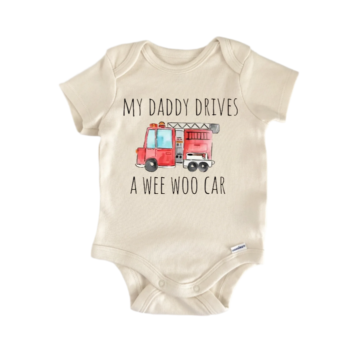A beige baby onesie with a printed design of a fire truck and the text "My Daddy Drives a WEE WOO CAR" printed on it.