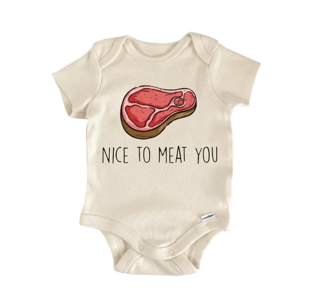 a baby onesie with a graphic of a piece of meat and the text "NICE TO MEAT YOU" printed on it.