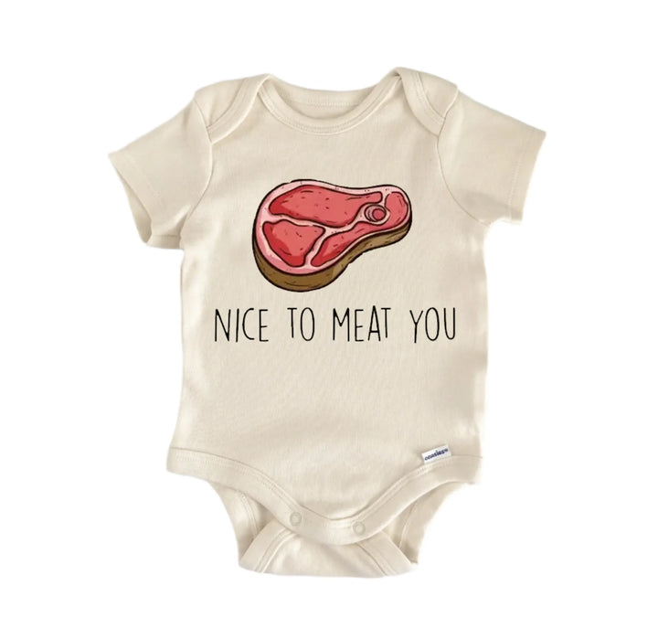 a baby onesie with a graphic of a piece of meat and the text "NICE TO MEAT YOU" printed on it.
