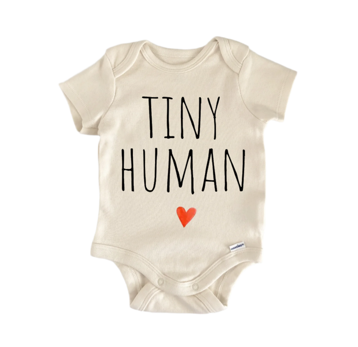 A beige baby onesie with the text "TINY HUMAN" printed on it.