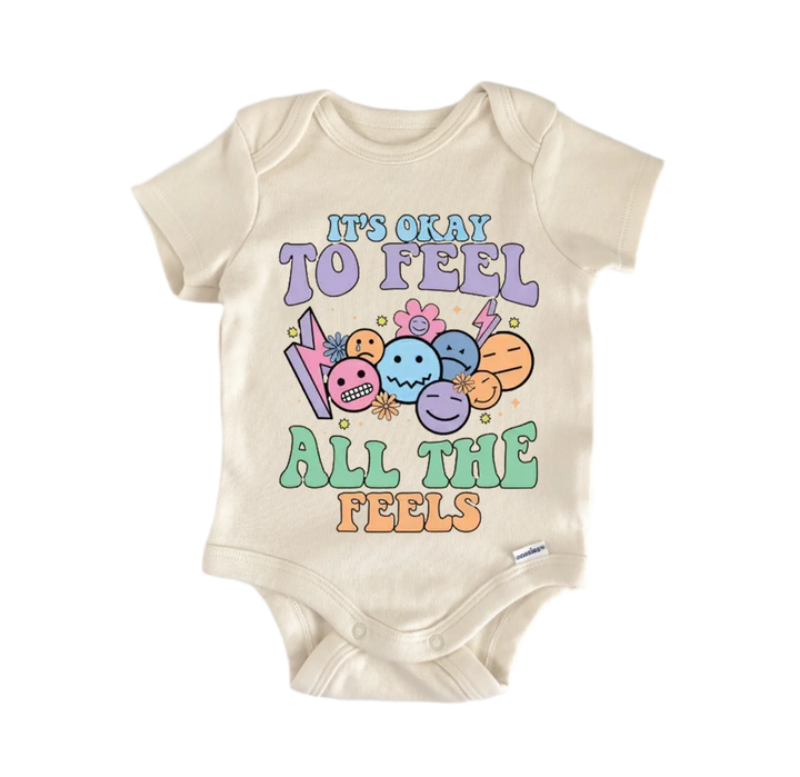 A beige baby onesie with a colorful graphic design and text printed on it.