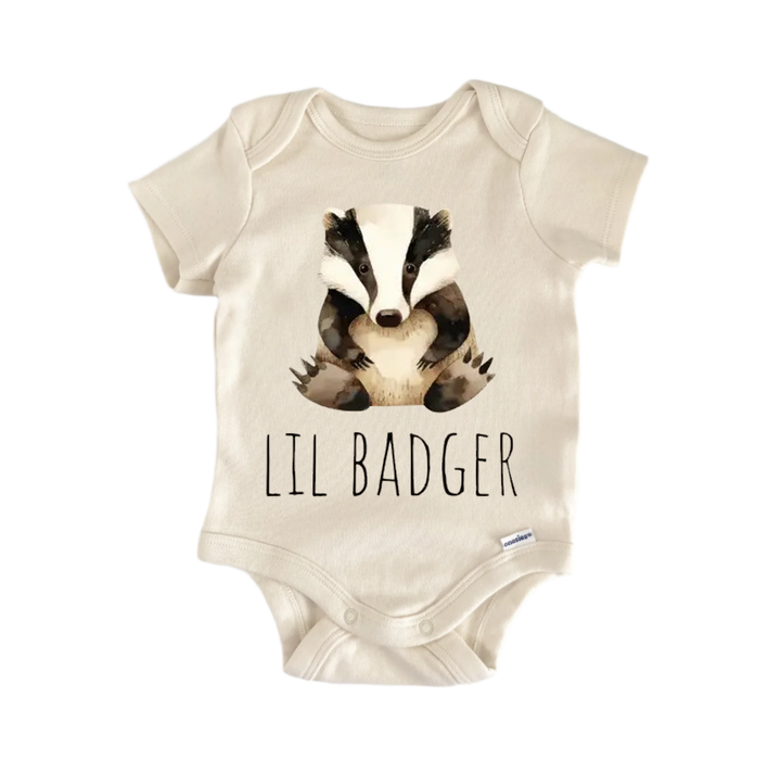A beige baby onesie with a printed image of a badger and the text "LIL BADGER" printed on it.