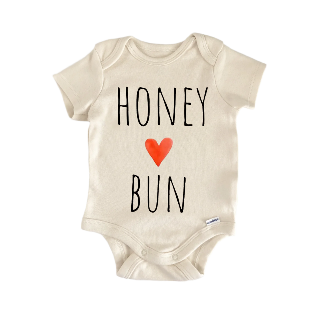 A beige baby onesie with the text "HONEY BUN" printed on it.