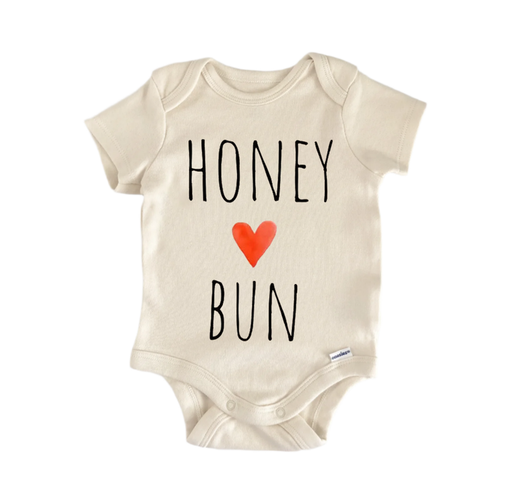 A beige baby onesie with the text "HONEY BUN" printed on it.