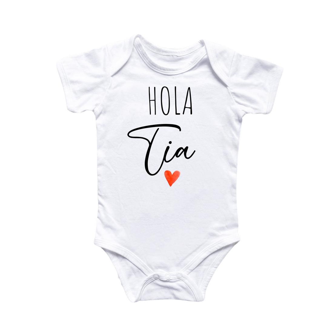 a white bodysuit with the words hola tia on it