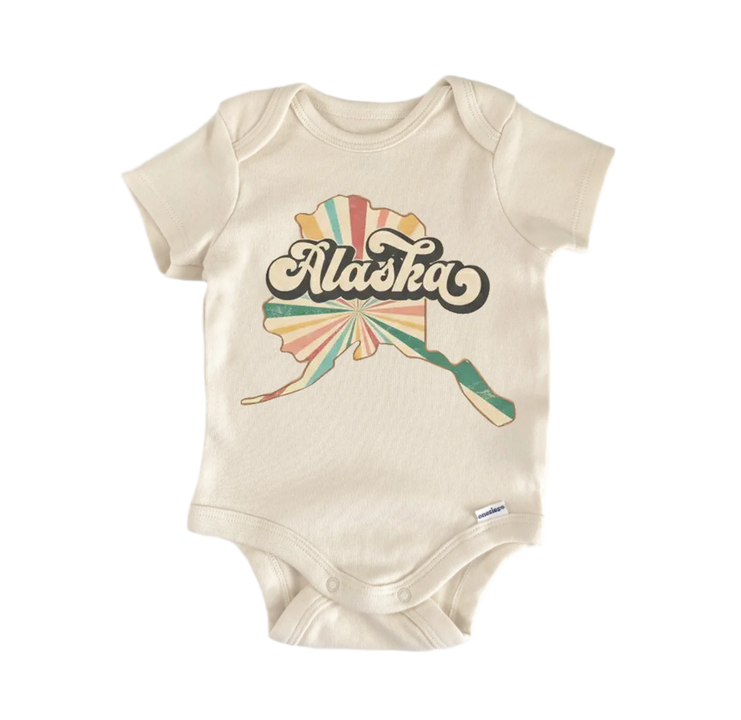 A beige baby onesie with a graphic of Alaska printed on it.
