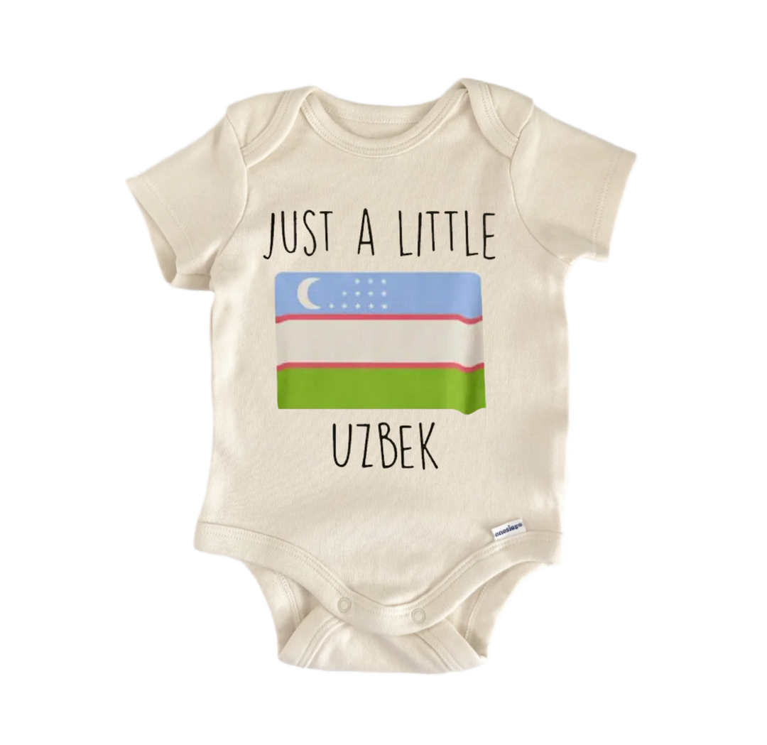 A beige baby onesie with the text "JUST A LITTLE UZBEK" printed on it, along with a small Uzbek flag graphic.