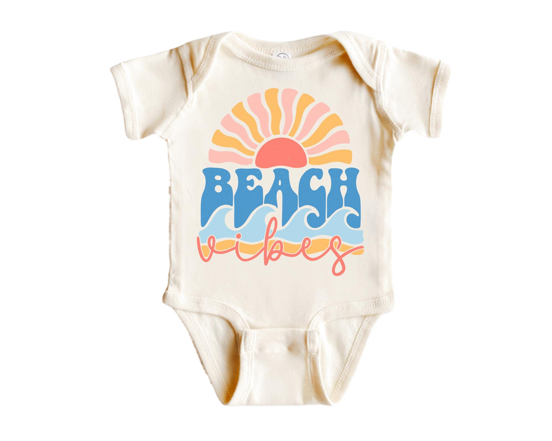 a baby bodysuit with the words beach babes printed on it