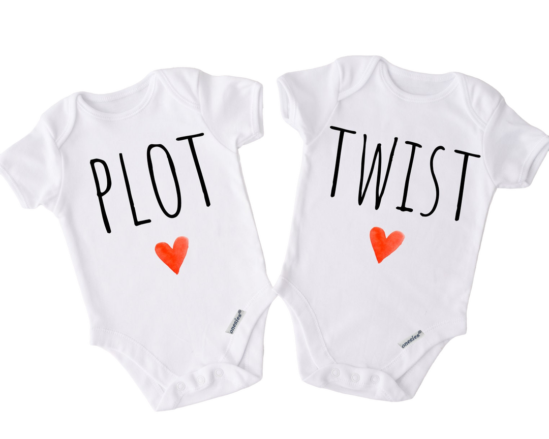 two white onesuits with red hearts on them
