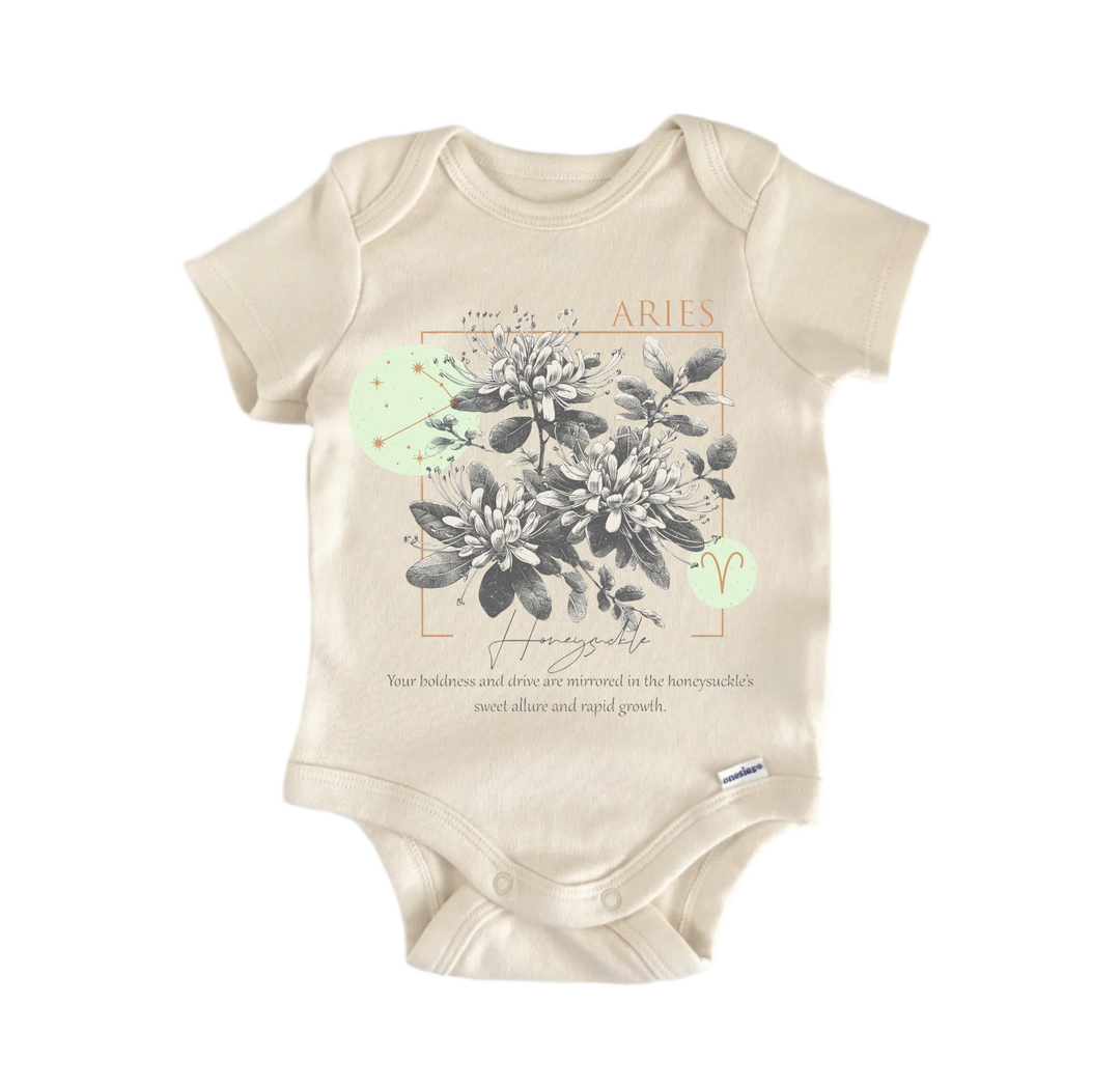 a beige baby onesie with a graphic design on the front. The design includes a floral pattern and a small zodiac symbol. The text on the onesie reads "Aries" and "Homozygote".