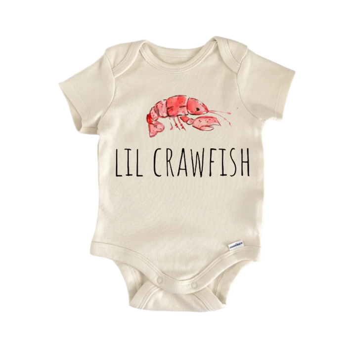 A beige baby onesie with a printed image of a red crawfish and the text "LIL CRAWFISH" printed on it.