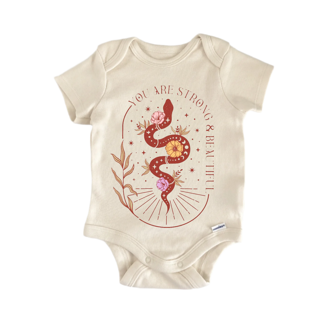 A beige baby onesie with a graphic design featuring a snake and flowers.