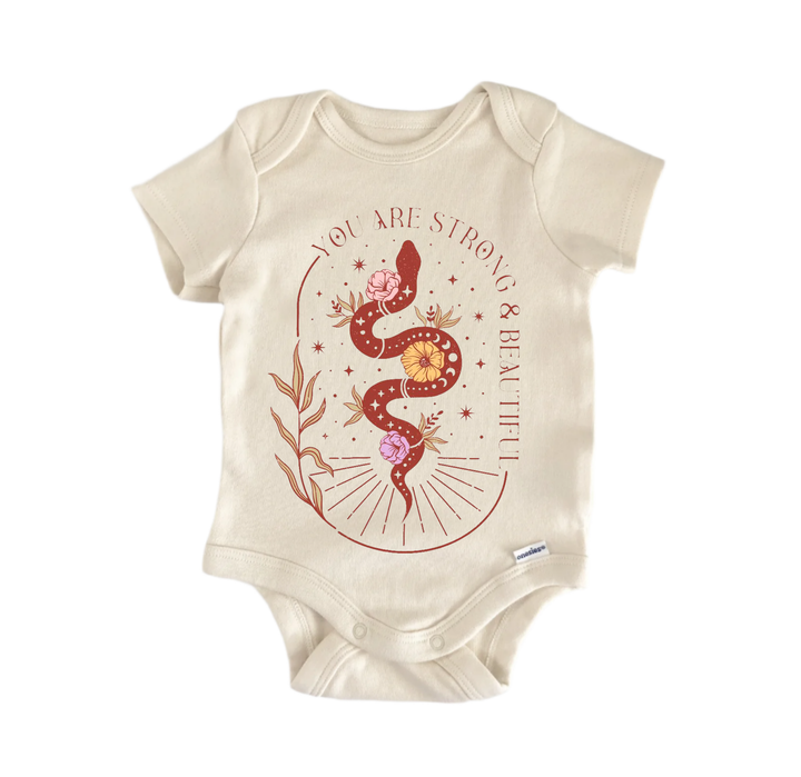 A beige baby onesie with a graphic design featuring a snake and flowers.