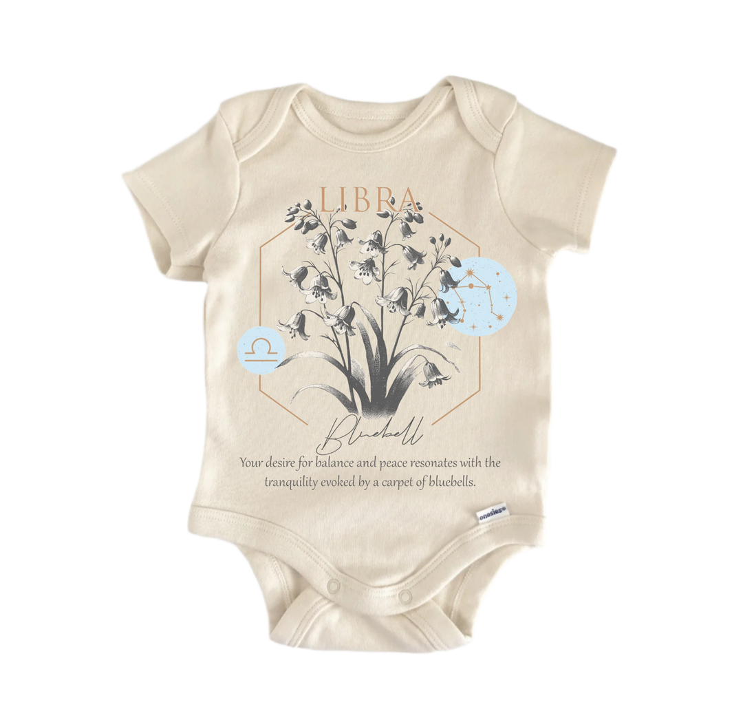 A beige baby onesie with a graphic design featuring a plant and the text "LIBRA Blooms" and "Your desire for balance and peace resonates with the tranquility evoked by a carpet of blooms."