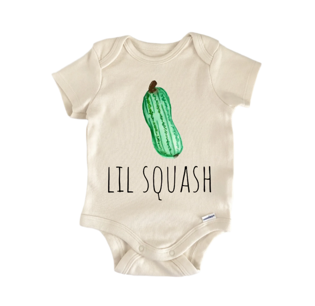 A beige baby onesie with a green squash graphic and the text "LIL SQUASH" printed on it.