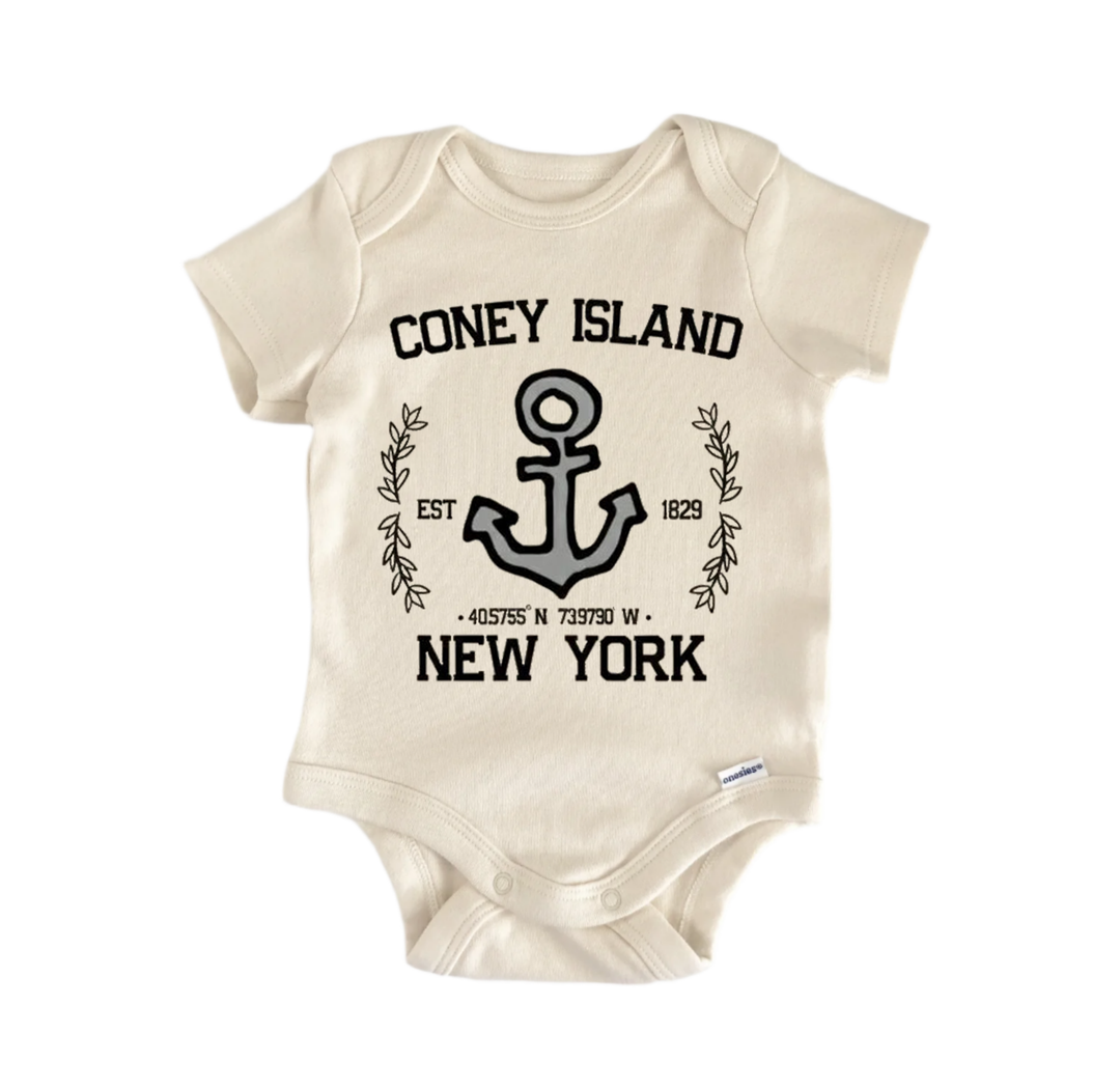 A beige baby onesie with a graphic design and text printed on it.