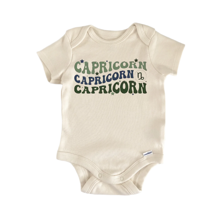A cream-colored baby onesie with the text "CAPRICORN" printed on it in a stylized font.