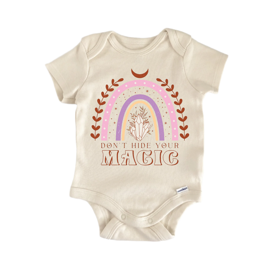 A beige baby onesie with a colorful graphic design and text printed on it.