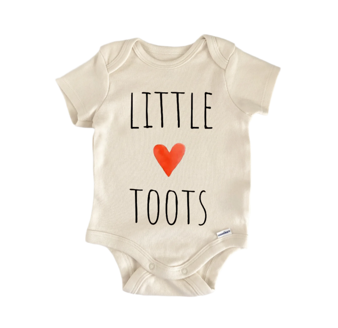 A beige baby onesie with the text "LITTLE TOOTS" printed on it.