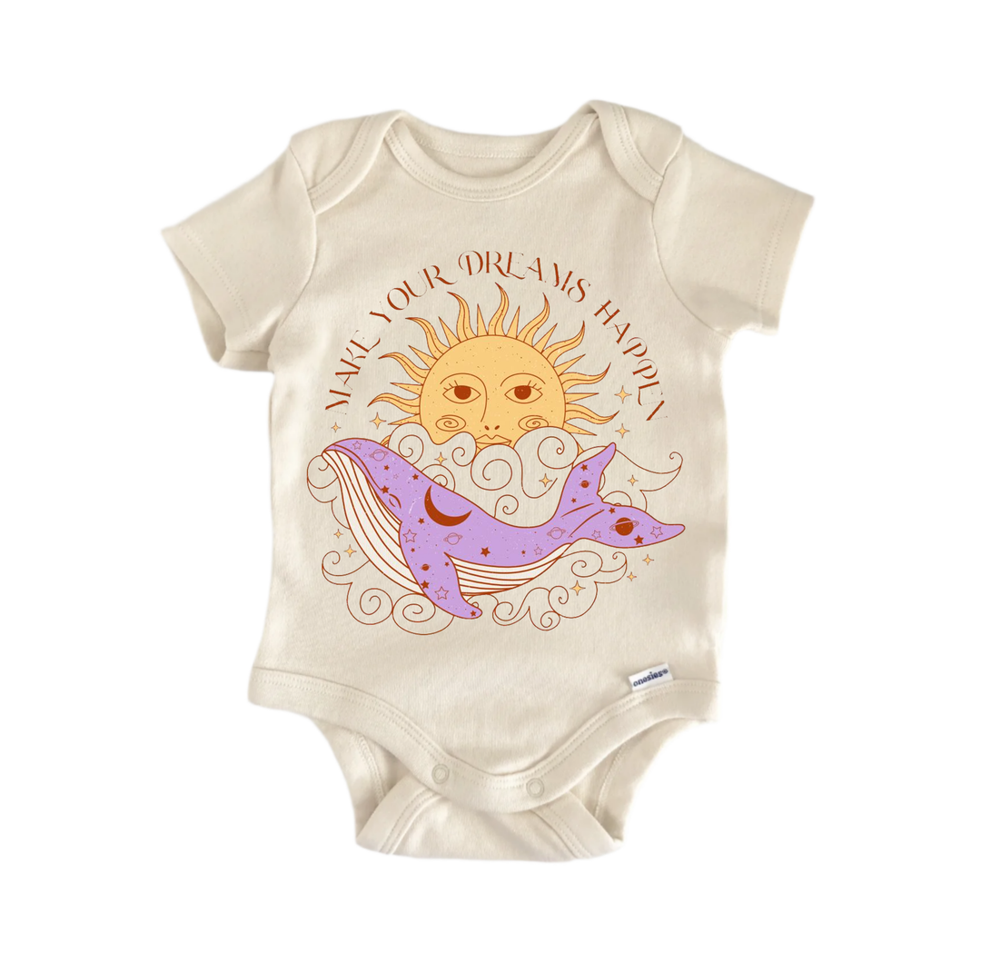 A beige baby onesie with a printed design featuring a sun, a whale, and a cloud. The text around the design reads "Make your dreams happy".