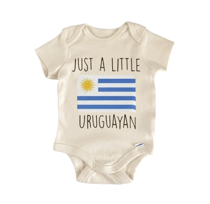 A beige baby onesie with the text "JUST A LITTLE URUGUAYAN" printed on it, along with a graphic of the Uruguay national flag.