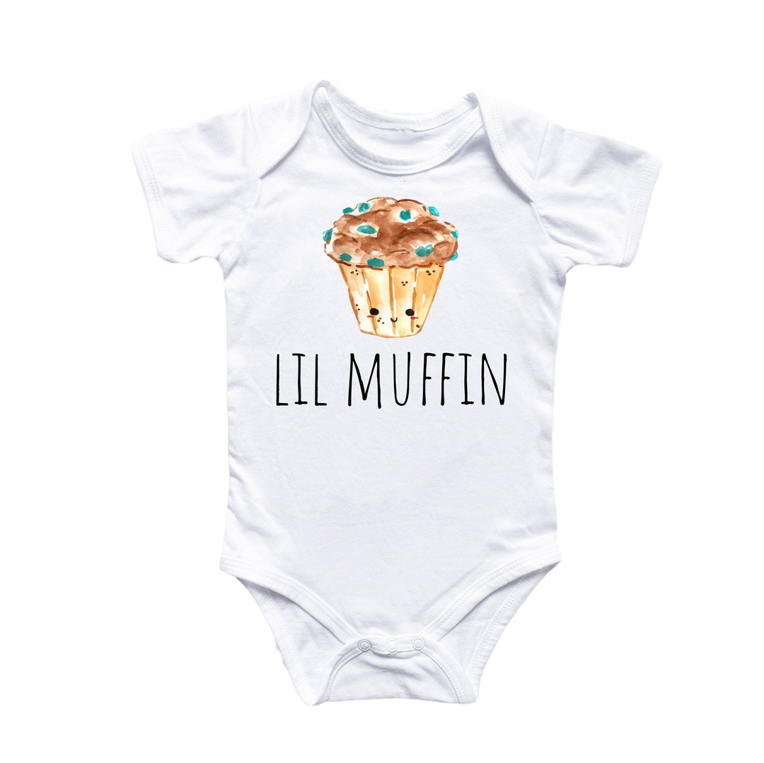 a white bodysuit with a picture of a muffin on it