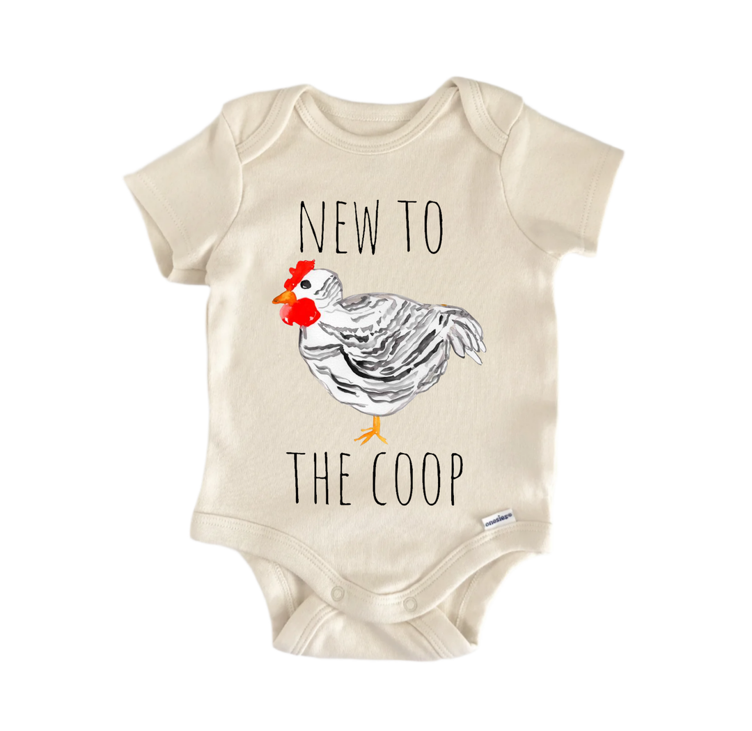 A beige baby onesie with a graphic of a chicken and the text "NEW TO THE COOP" printed on it.