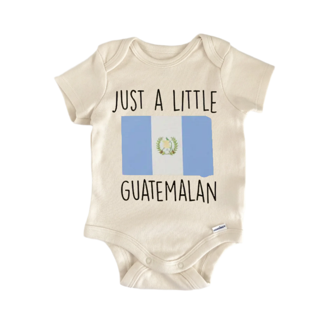 A beige baby onesie with the text "JUST A LITTLE GUATEMALAN" printed on it, along with a small image of the Guatemala flag.