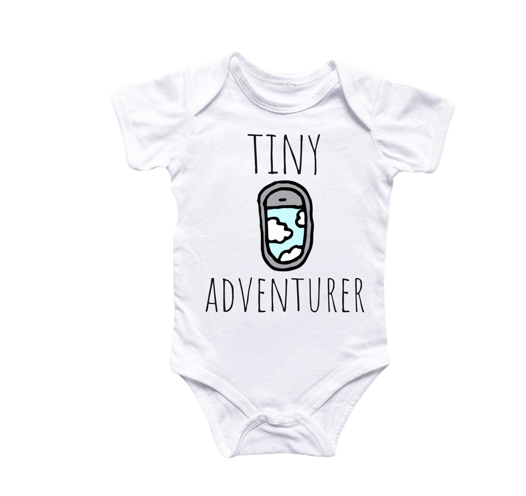 a white bodysuit with the words tiny adventurer printed on it