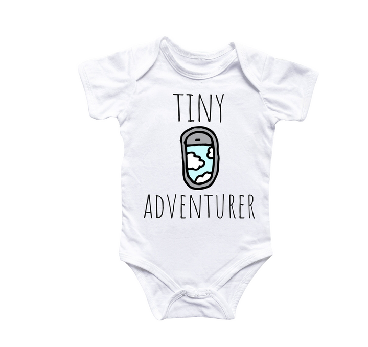 a white bodysuit with the words tiny adventurer printed on it