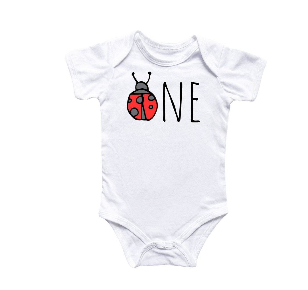 a white bodysuit with a ladybug on it