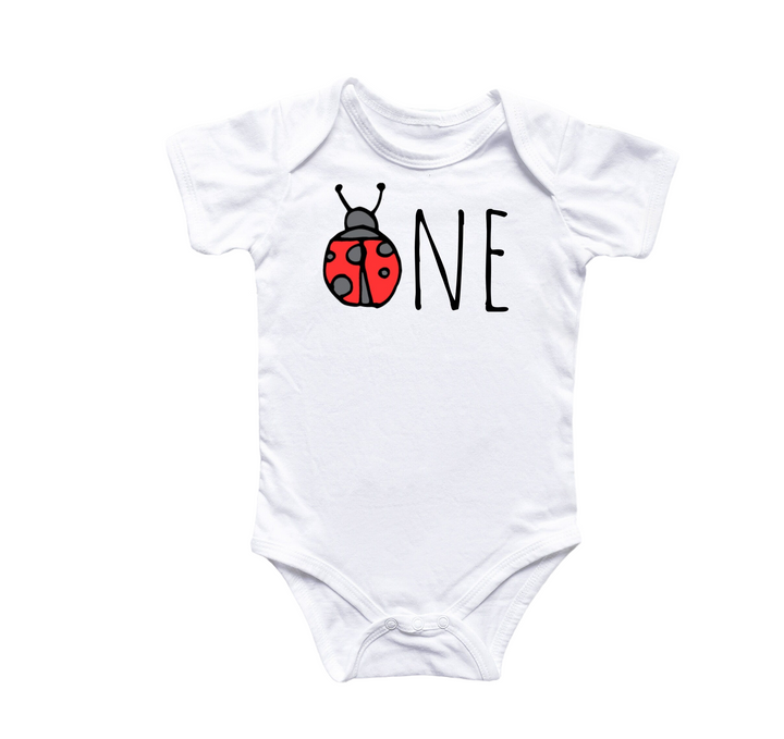 a white bodysuit with a ladybug on it