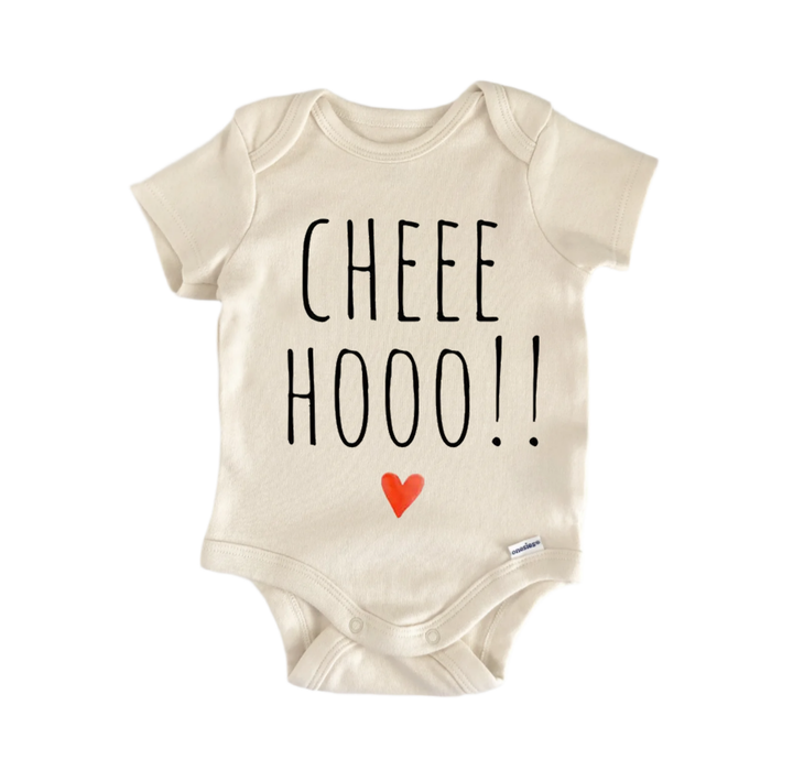 A beige baby onesie with the text "CHEE HOO!" printed on it, along with a small red heart symbol.