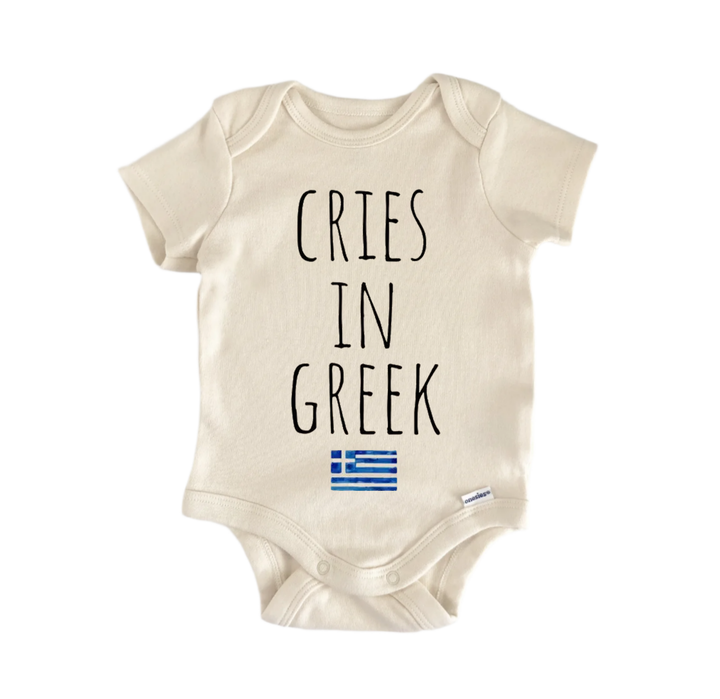 A beige baby onesie with the text "CRIES IN GREK" printed on it, along with a small Greek flag below the text.