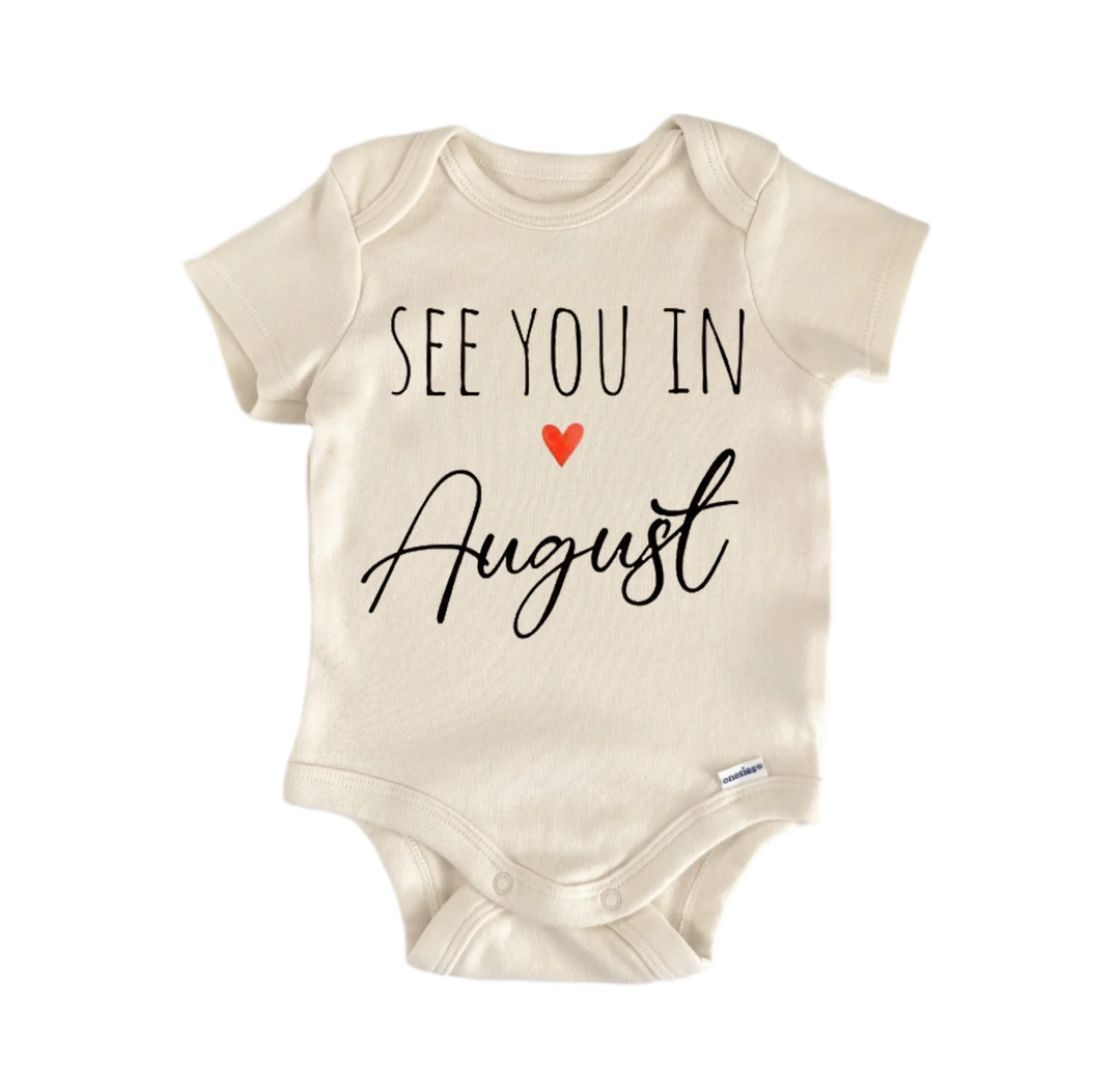 A beige baby onesie with the text "See you in August" printed on it.