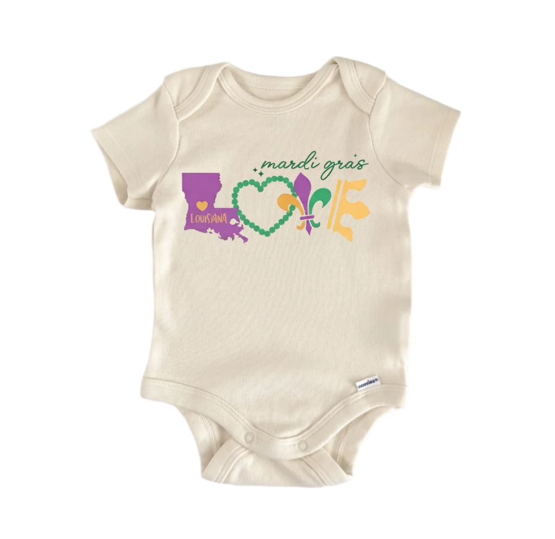 A beige baby onesie with a graphic design featuring the text "mardi gras love" and various colorful symbols associated with the Mardi Gras celebration.