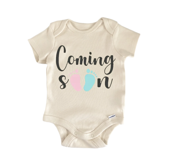 A beige baby onesie with the text "Coming soon" printed on it.