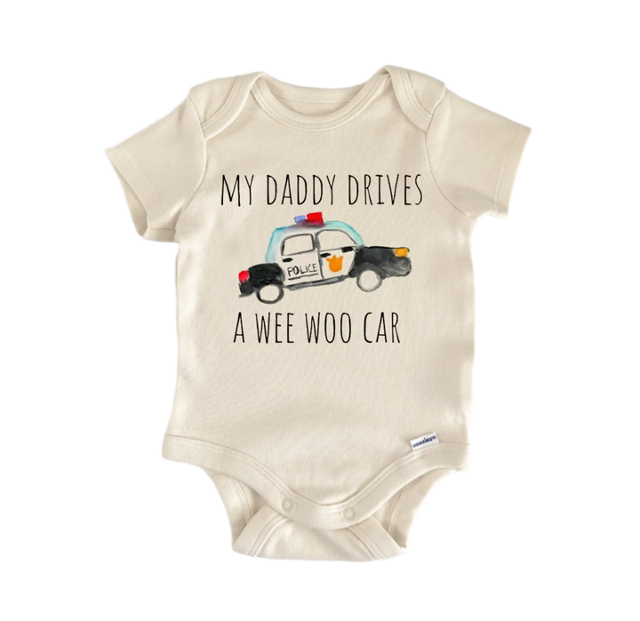 A beige baby onesie with a printed design of a police car and the text "My Daddy drives a Wee Woo Car" printed on it.