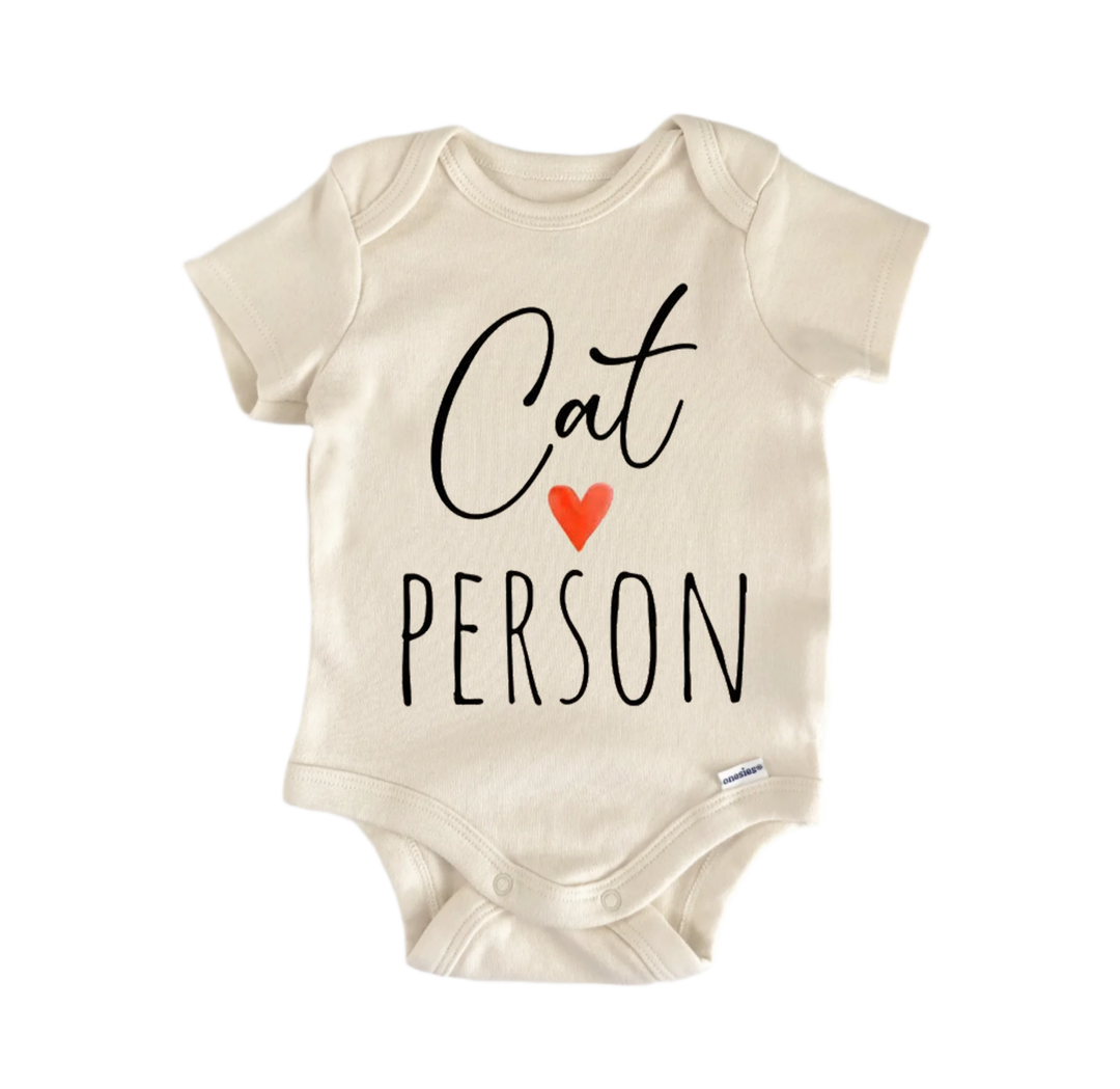 A beige baby onesie with the text "Cat Person" printed on it.