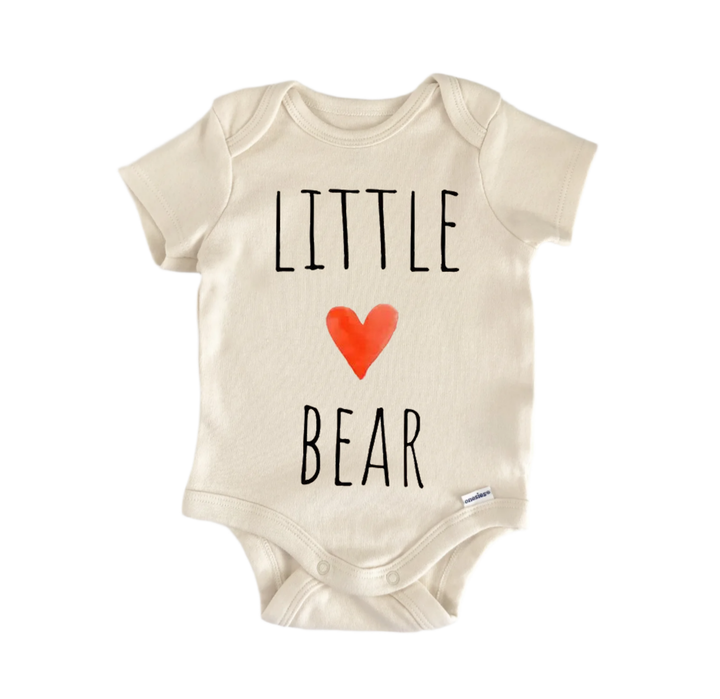 A beige baby onesie with the text "LITTLE BEAR" printed on it, along with a red heart symbol.