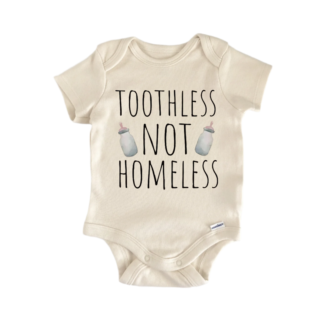 A beige baby onesie with the text "TOOTHLESS NOT HOMELESS" printed on it.