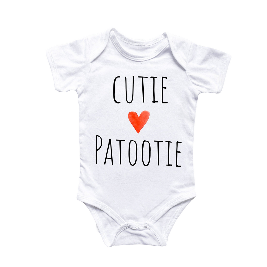 a white bodysuit with a red heart that says cutie patootie