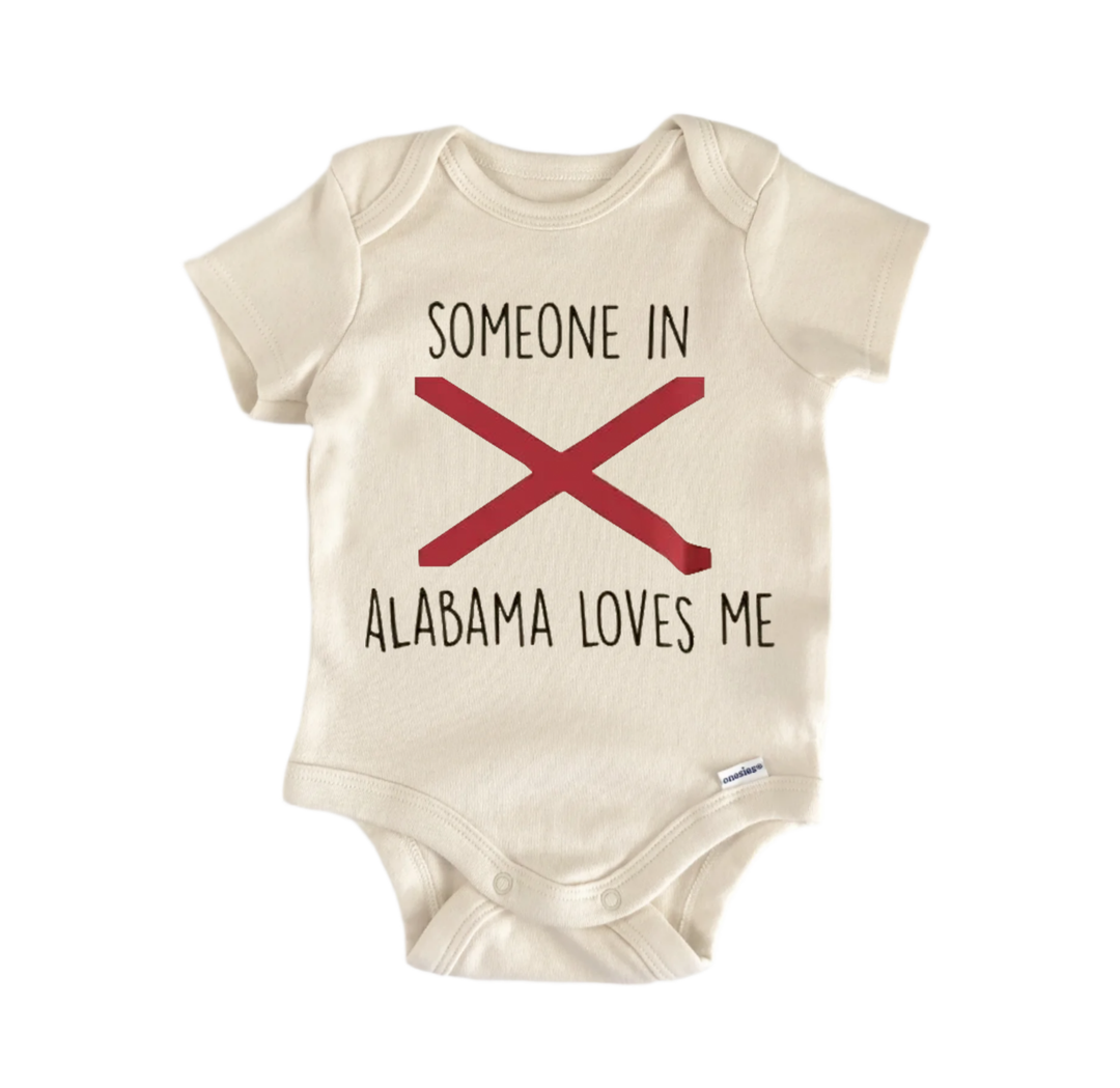 A beige baby onesie with the text "SOMEONE IN ALABAMA LOVES ME" printed on it.