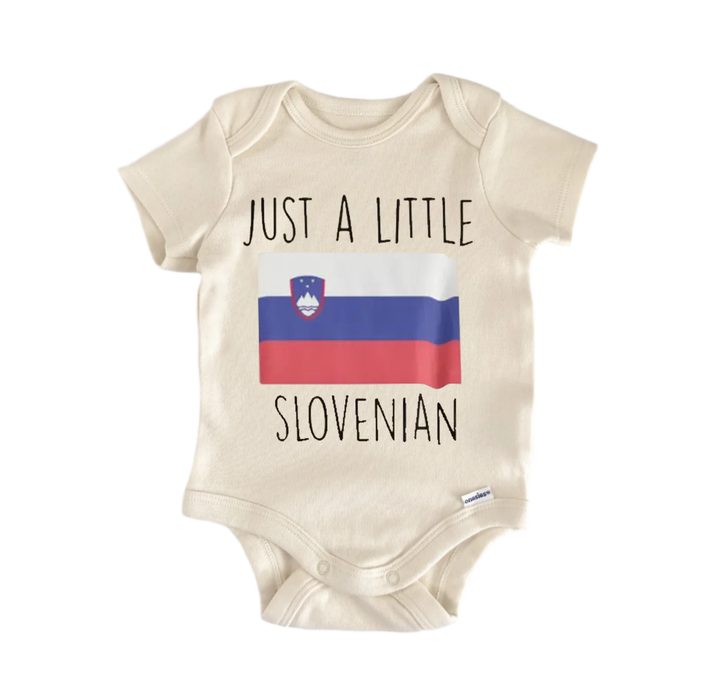 A beige baby onesie with the text "JUST A LITTLE SLOVENIAN" printed on it, along with a small image of the flag of Slovenia.