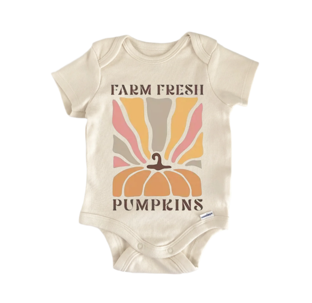 A beige baby onesie with a graphic design featuring a pumpkin and the text "FARM FRESH PUMPS" printed on it.