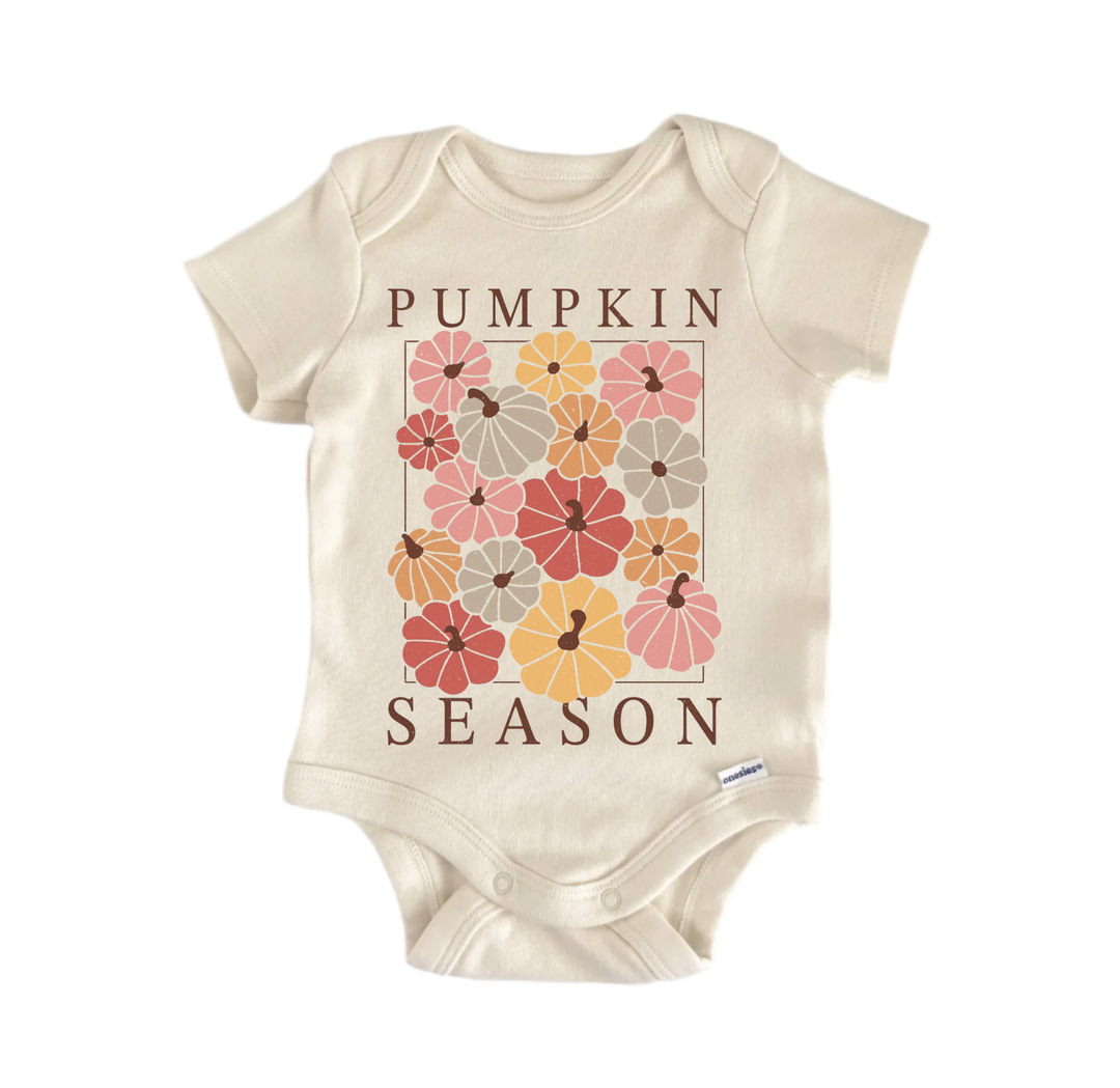 A beige baby onesie with a graphic design of pumpkins and the text "Pumpkin Season" printed on it.